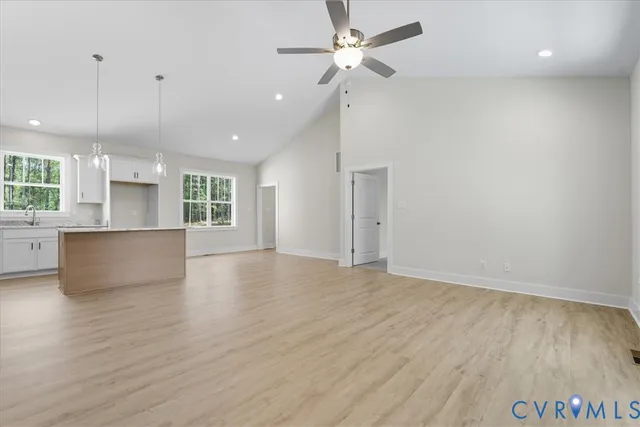 a view of a kitchen with a sink and a refrigerator