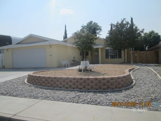 405 Vista Street Ridgecrest, CA 93555 - Photo 1 of 16 a front view of a house with a yard