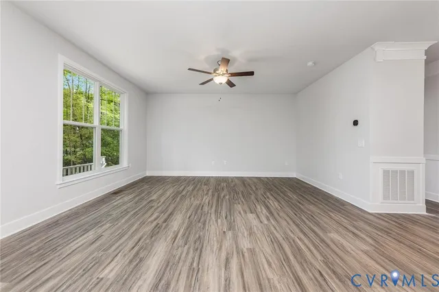wooden floor in an empty room with a window