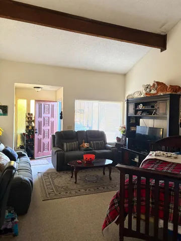 a living room with furniture and a piano