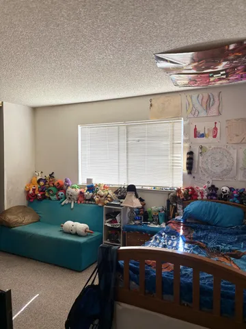 a bedroom with a bed and a large mirror