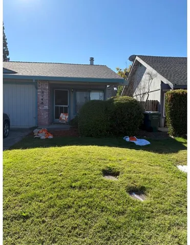 a front view of house with yard and trees