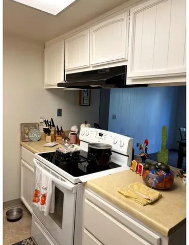 a kitchen with a stove and cabinets