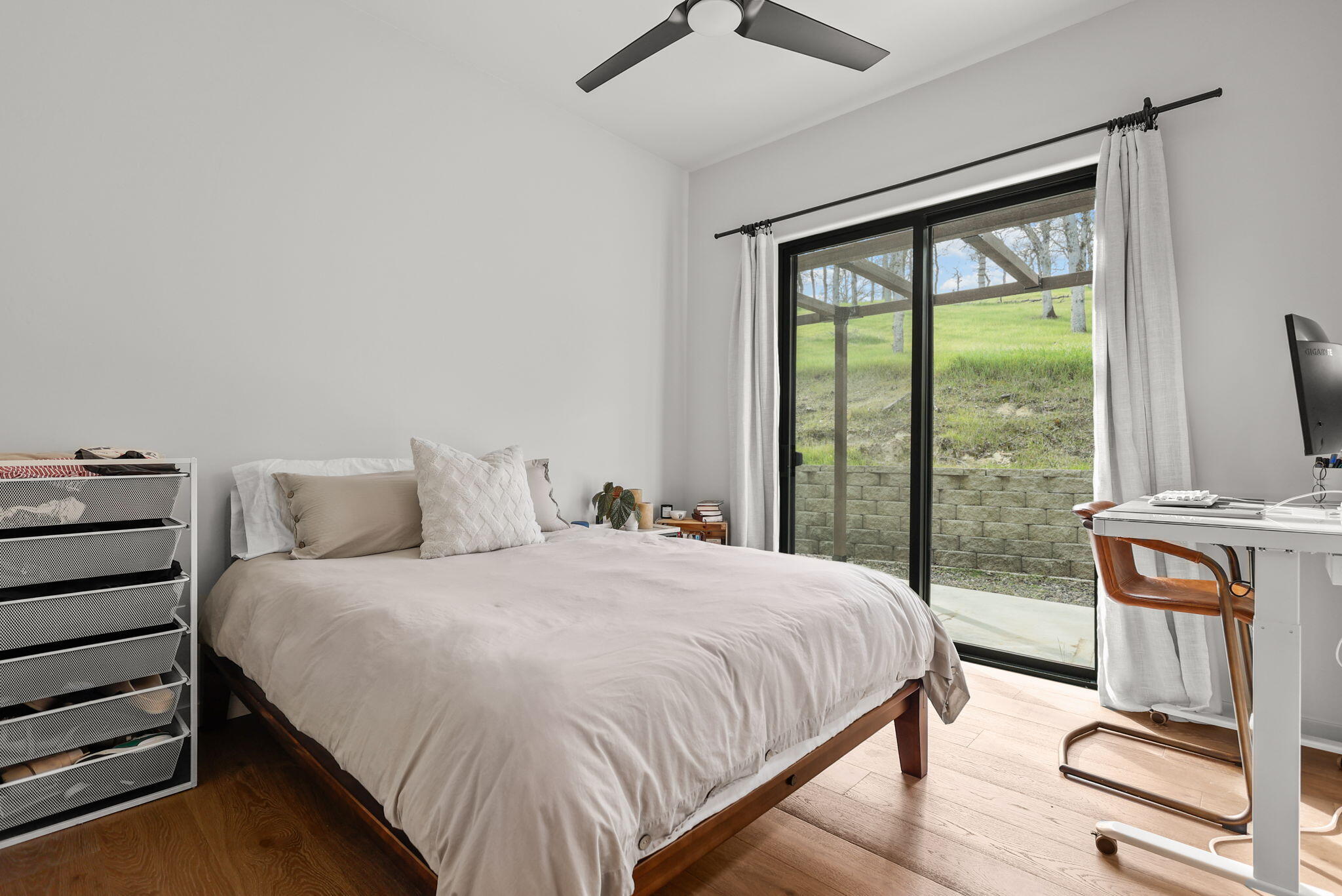 8202 Maynard Road Palo Cedro, CA 96073 - Photo 41 of 74 a bedroom with a bed and wooden floor