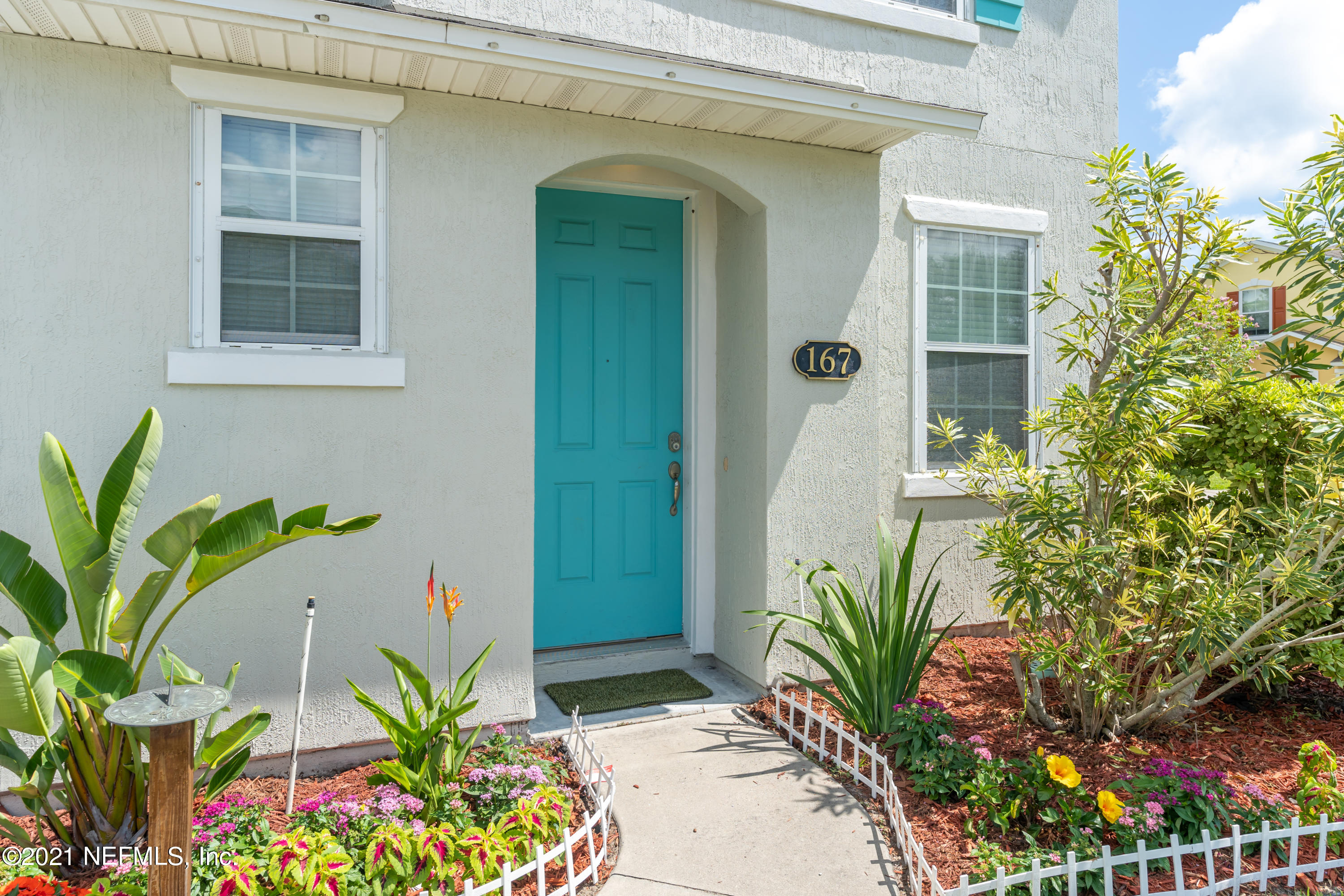167 Bay Bridge Drive St. Augustine, FL 32080 - Photo 2 of 32 a potted plant sitting in front of a house