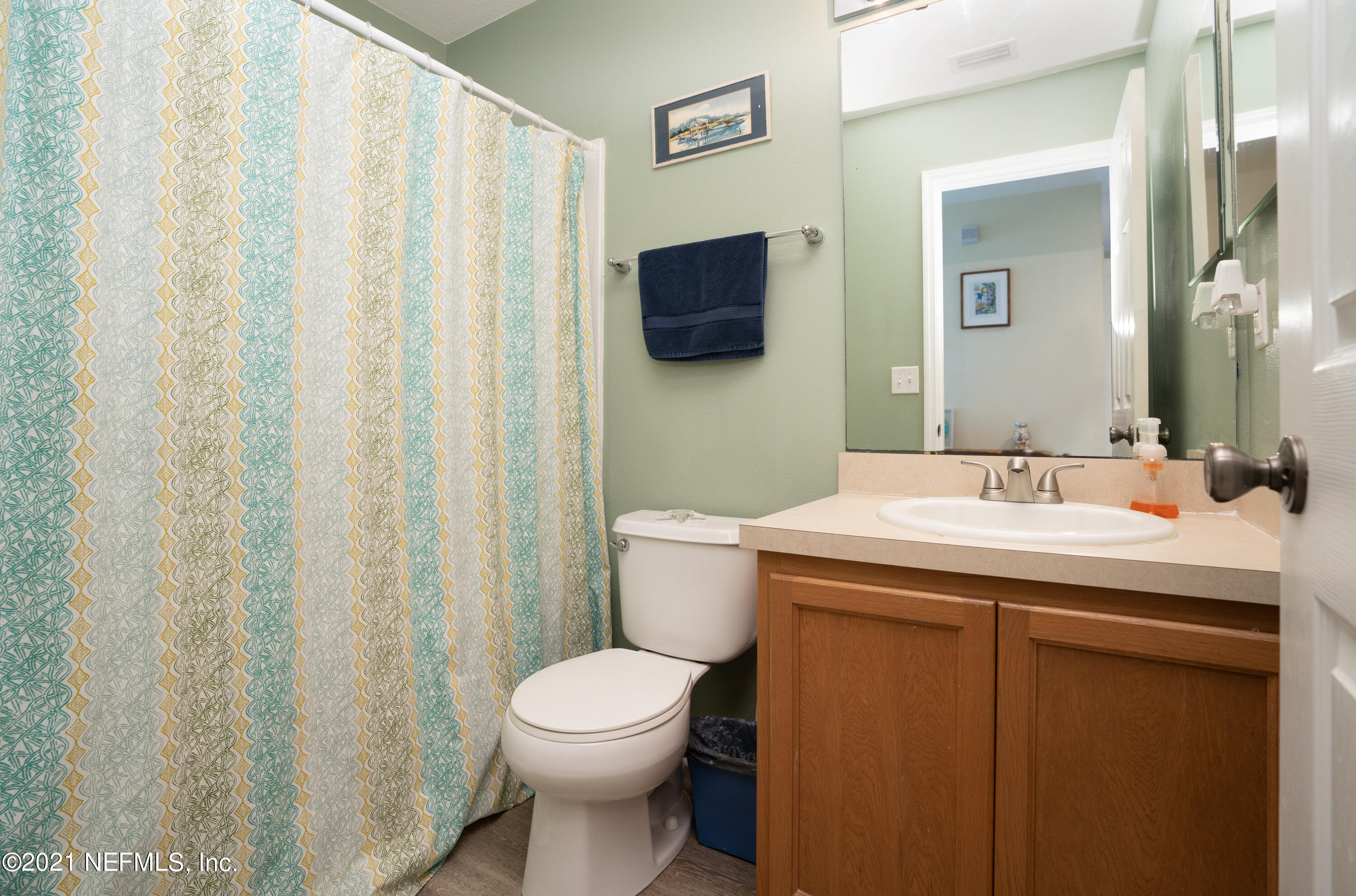 167 Bay Bridge Drive St. Augustine, FL 32080 - Photo 23 of 32 a bathroom with a sink a toilet and shower curtain
