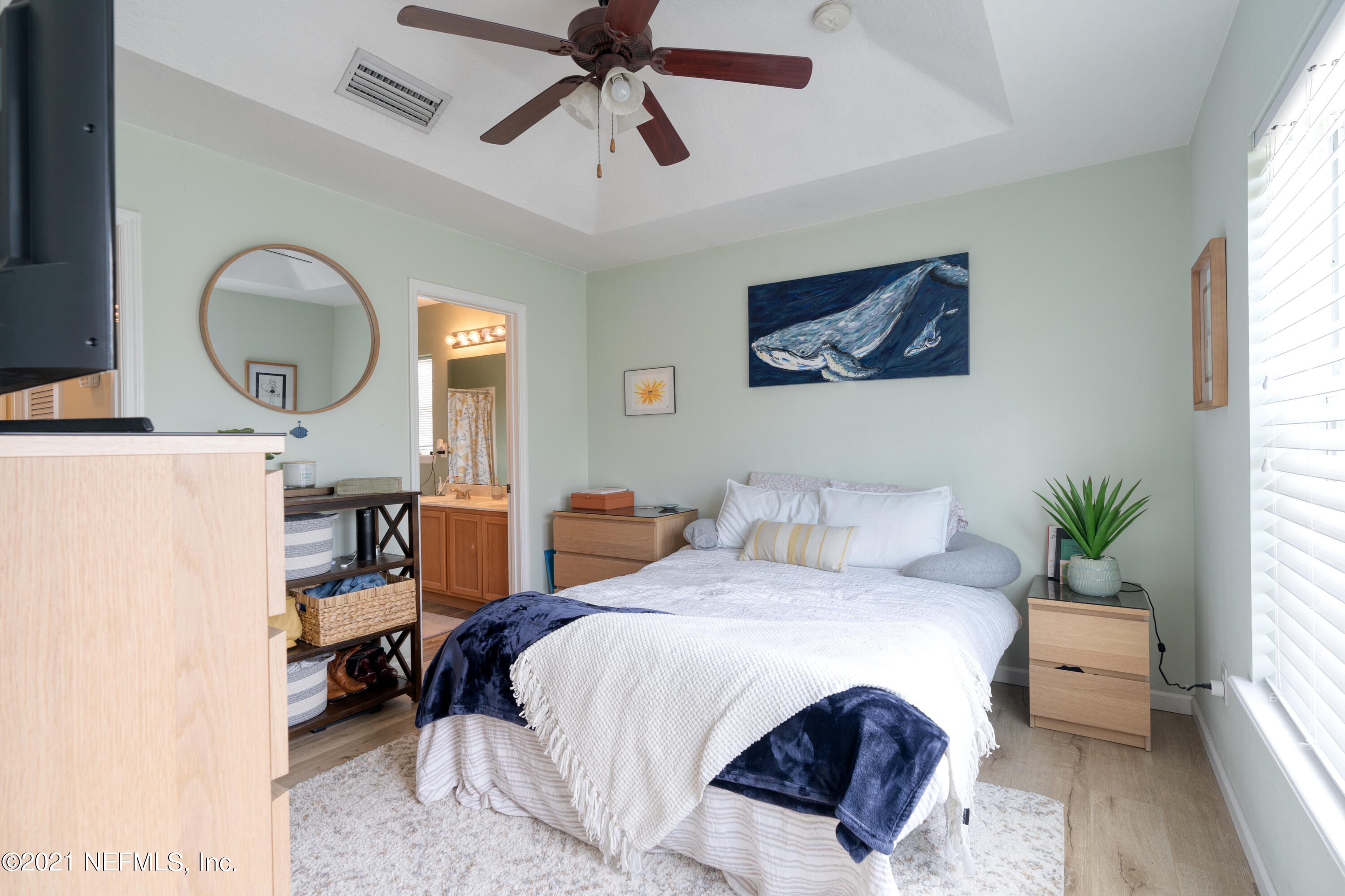 167 Bay Bridge Drive St. Augustine, FL 32080 - Photo 28 of 32 a bedroom with a bed a mirror and a large window