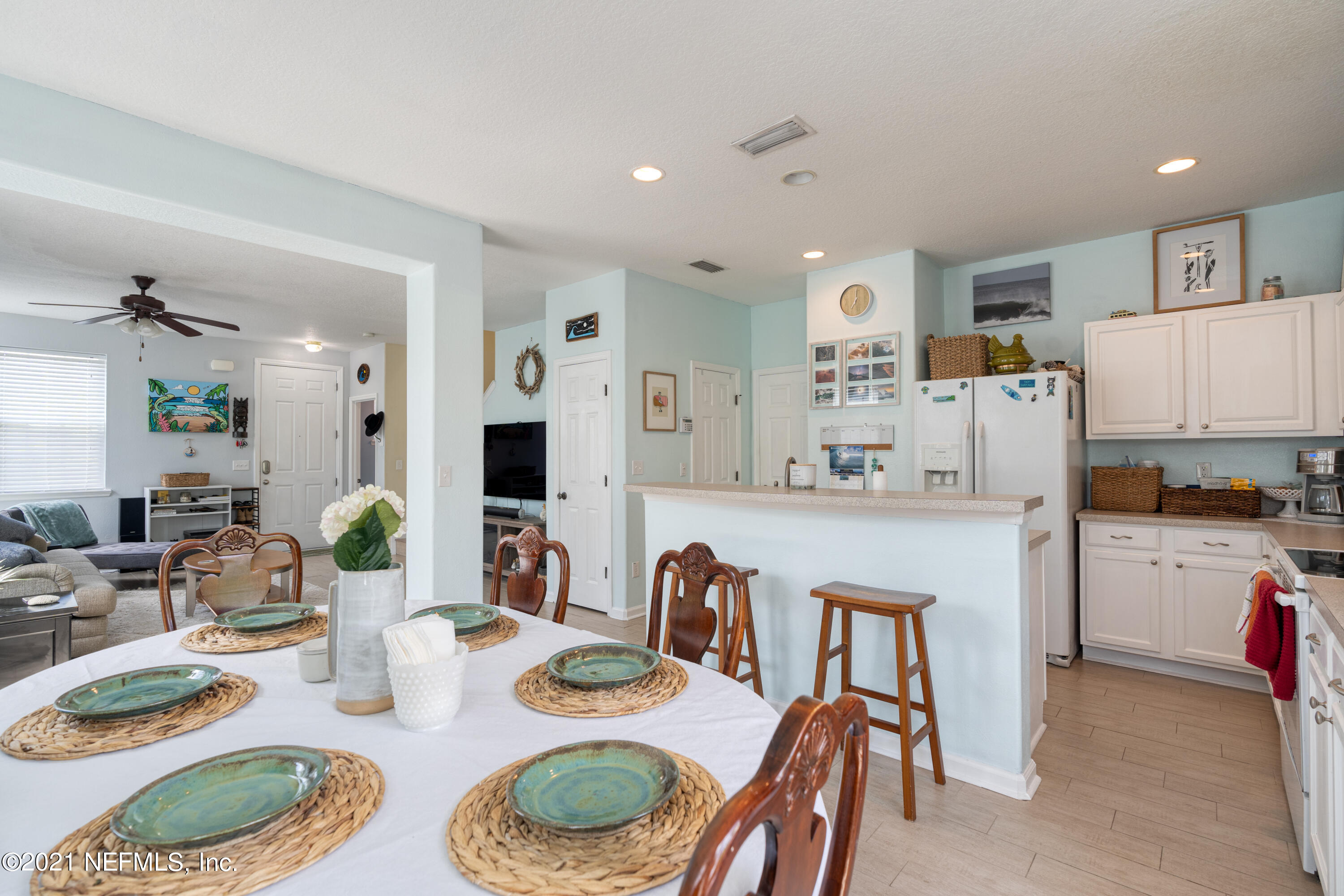 167 Bay Bridge Drive St. Augustine, FL 32080 - Photo 5 of 32 a kitchen with kitchen island granite countertop stainless steel appliances lots of white cabinets and couches