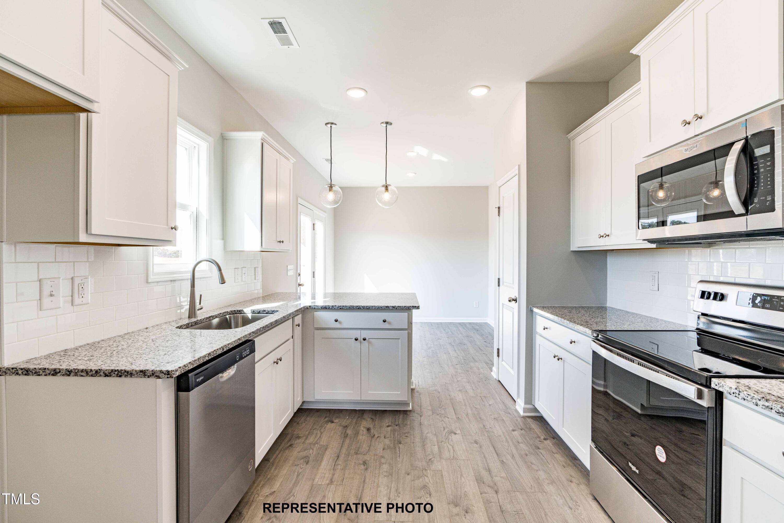 106 Legolas Court Middlesex, NC 27557 - Photo 2 of 11 a kitchen with stainless steel appliances granite countertop a sink stove and refrigerator