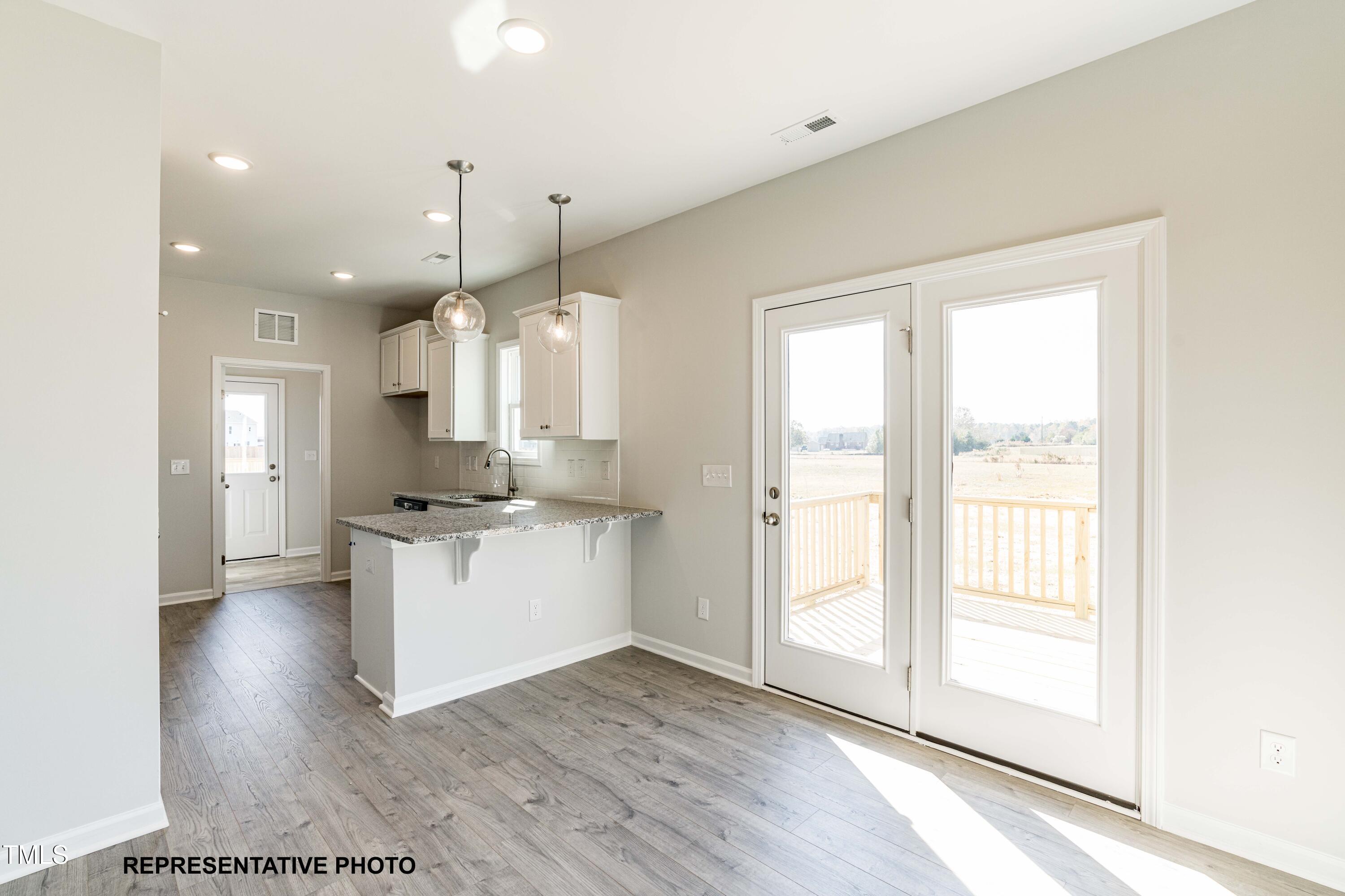 106 Legolas Court Middlesex, NC 27557 - Photo 6 of 11 a kitchen with kitchen island white cabinets and white appliances