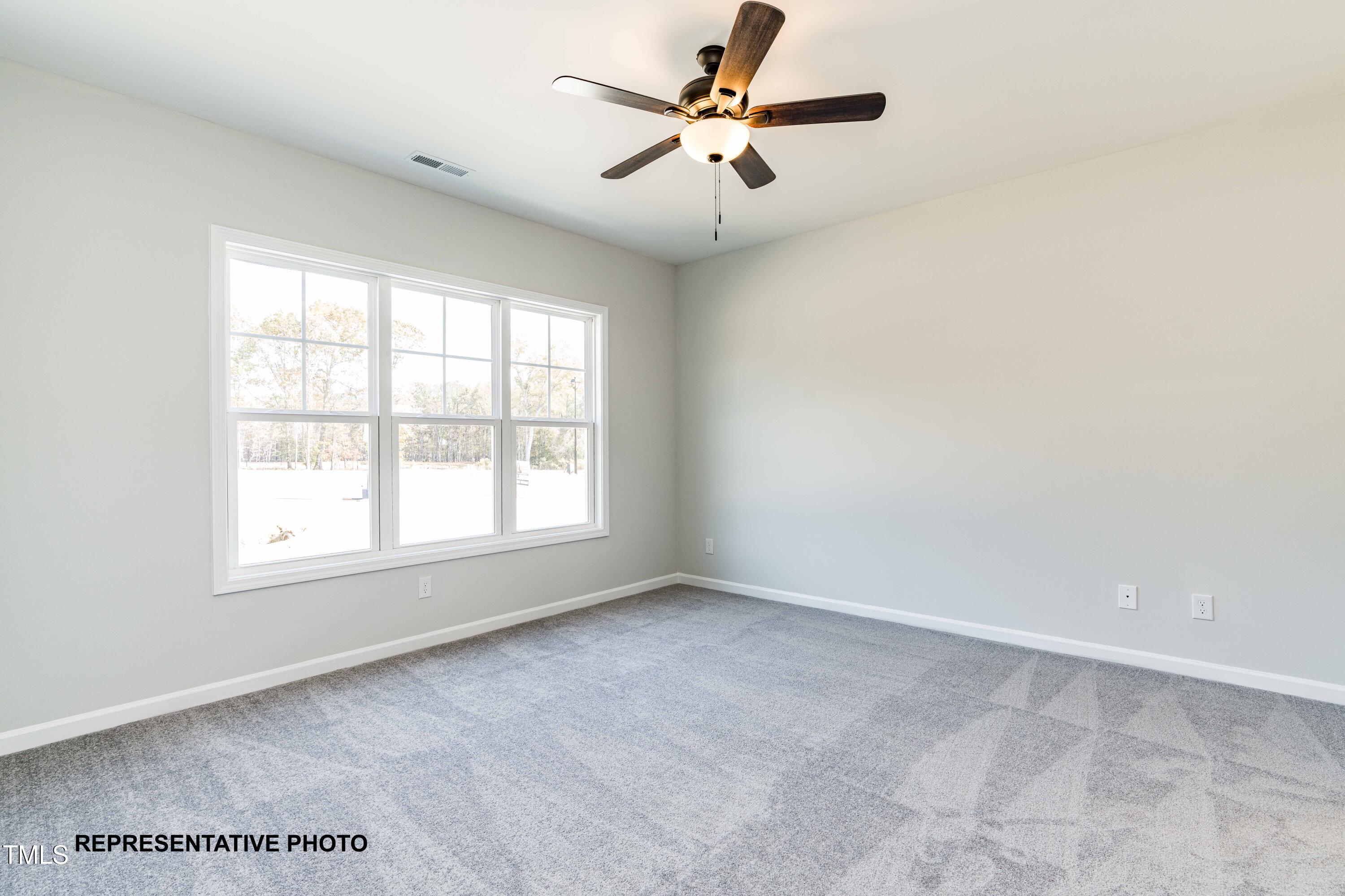 106 Legolas Court Middlesex, NC 27557 - Photo 9 of 11 an empty room with windows and fan