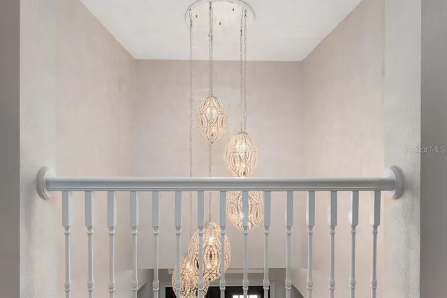 a living room with furniture a rug and a chandelier