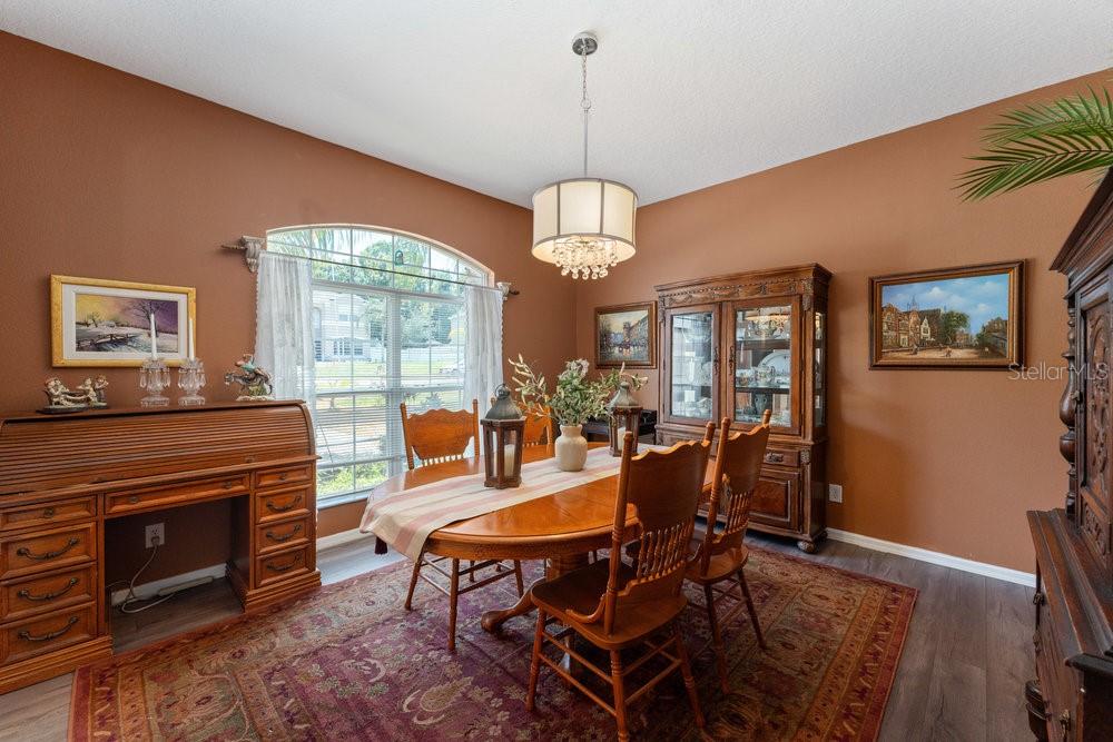 3463 Creek Run Lane Eustis, FL 32736 - Photo 12 of 83 a dining room with furniture a chandelier and wooden floor
