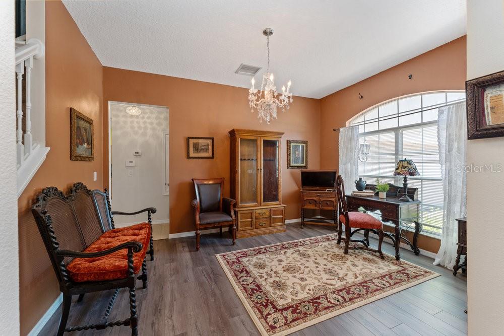3463 Creek Run Lane Eustis, FL 32736 - Photo 15 of 83 a living room with furniture a rug and a chandelier