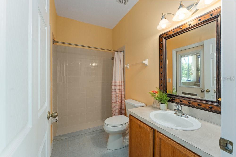 3463 Creek Run Lane Eustis, FL 32736 - Photo 24 of 83 a bathroom with a granite countertop sink toilet and shower