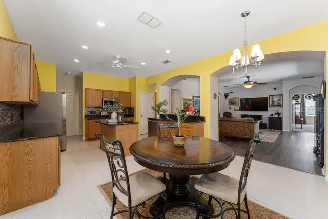 a spacious bedroom with a bed and a chandelier