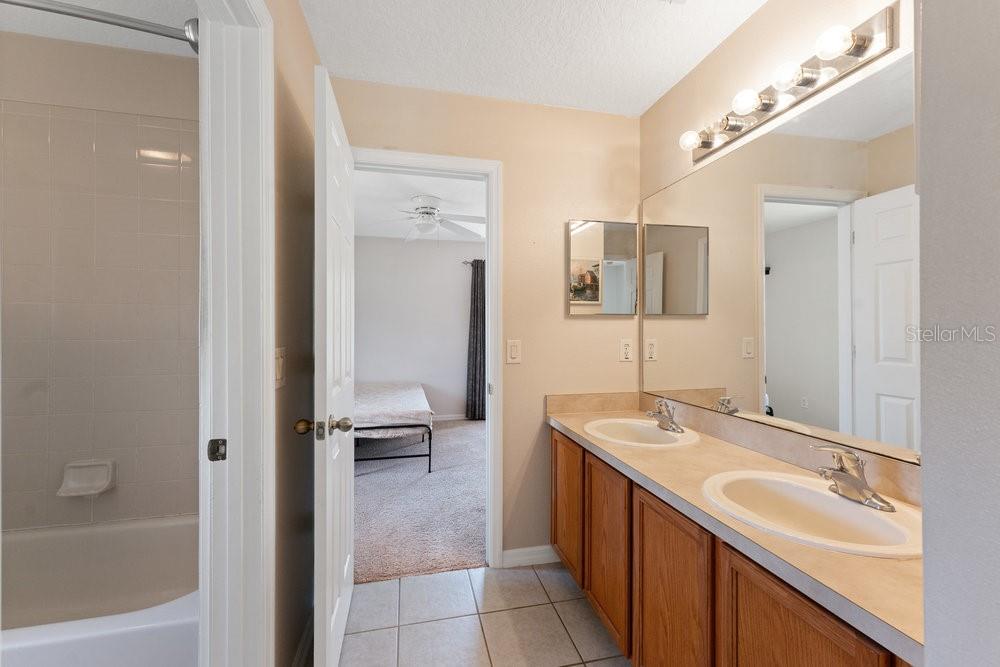 3463 Creek Run Lane Eustis, FL 32736 - Photo 45 of 83 a bathroom with a sink and a mirror
