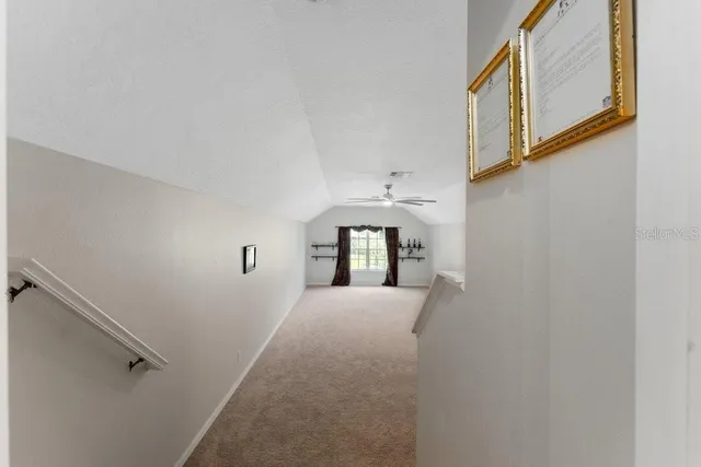 a view of a patio with a table and chairs under an umbrella