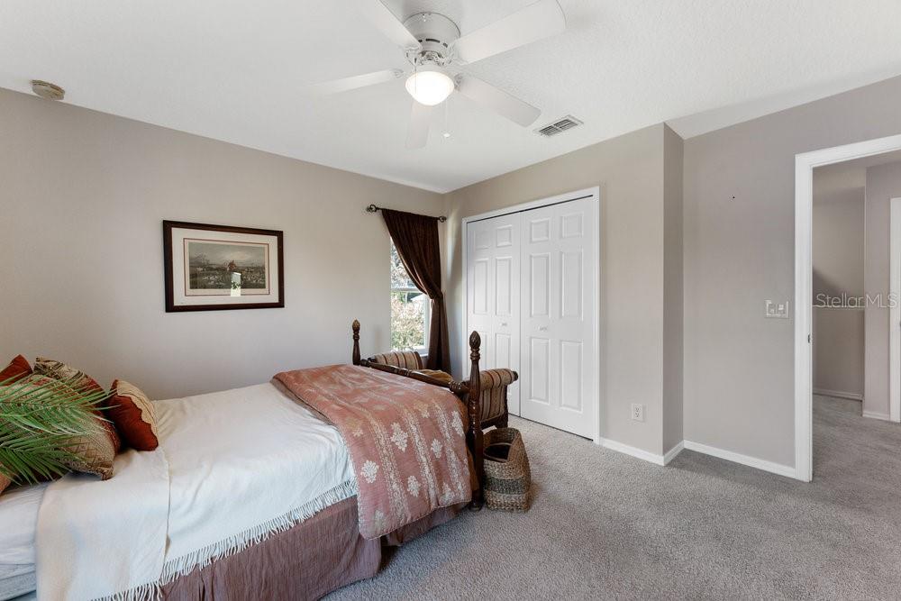 3463 Creek Run Lane Eustis, FL 32736 - Photo 62 of 83 a bedroom with a bed and a chandelier