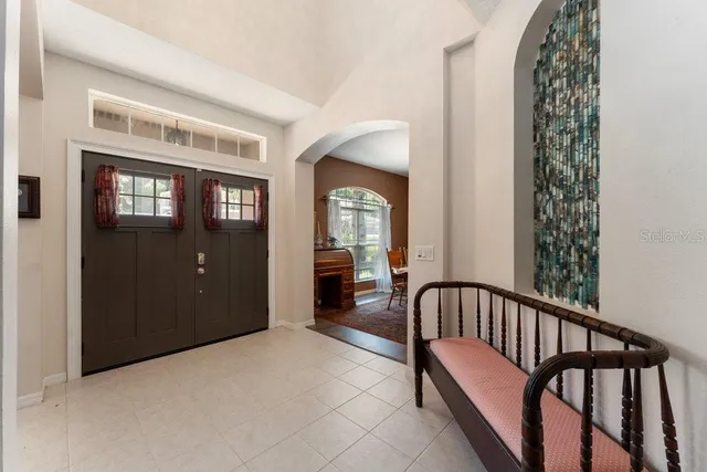 a view of livingroom with furniture fireplace and windows