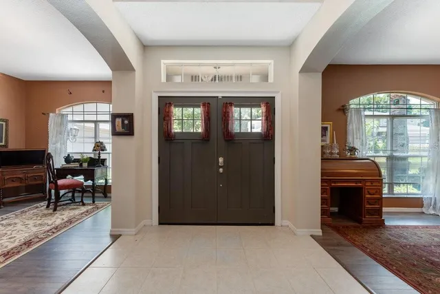 a dining room with furniture a chandelier and wooden floor