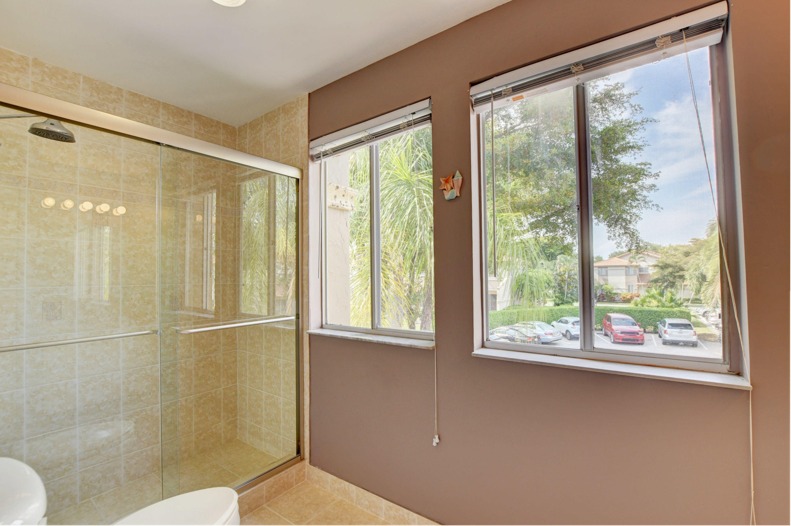 6746 Via Regina Boca Raton, FL 33433 - Photo 19 of 25 a bathroom with a window and a shower