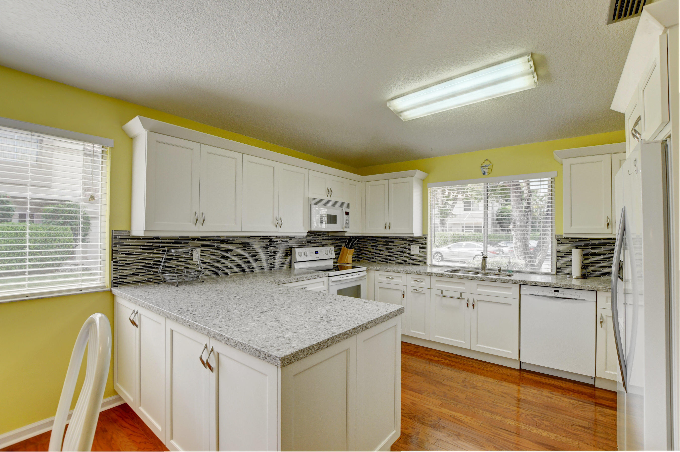 6746 Via Regina Boca Raton, FL 33433 - Photo 3 of 25 a kitchen that has a sink and a stove in it