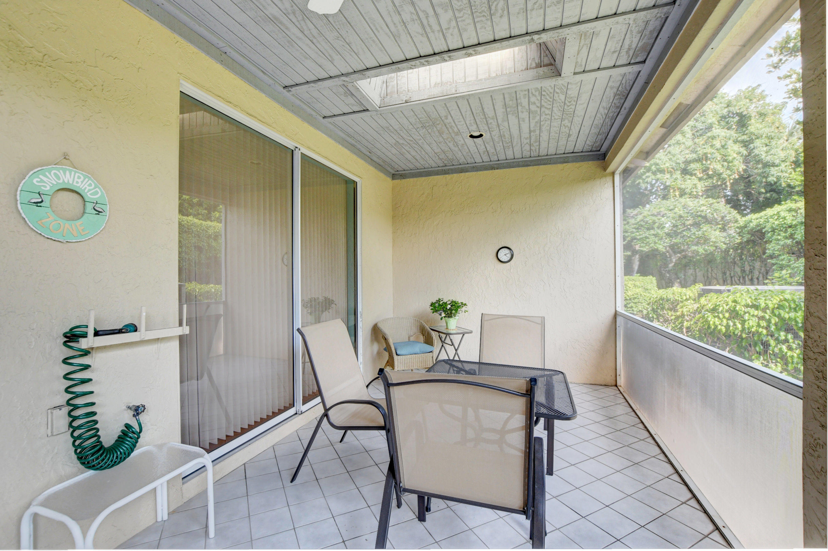 6746 Via Regina Boca Raton, FL 33433 - Photo 22 of 25 a dining room with furniture and a floor to ceiling window