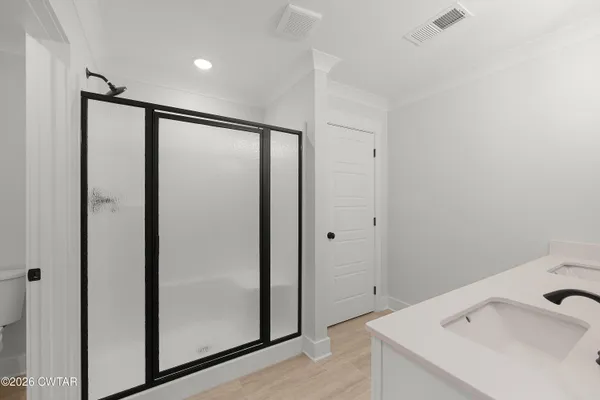 a bathroom with a shower and sink