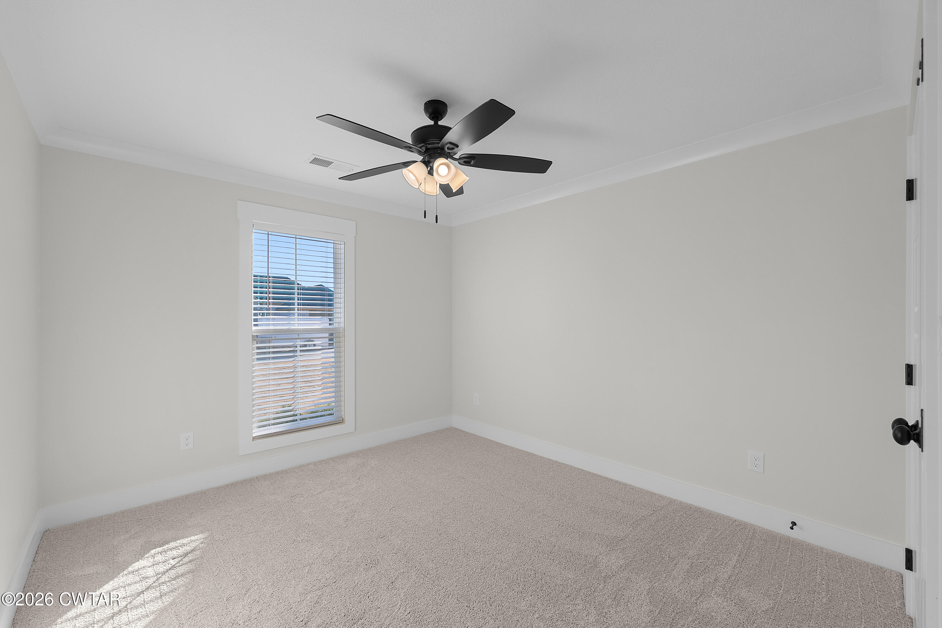 17 Easington Cove Jackson, TN 38305 - Photo 17 of 19 an empty room with windows and fan