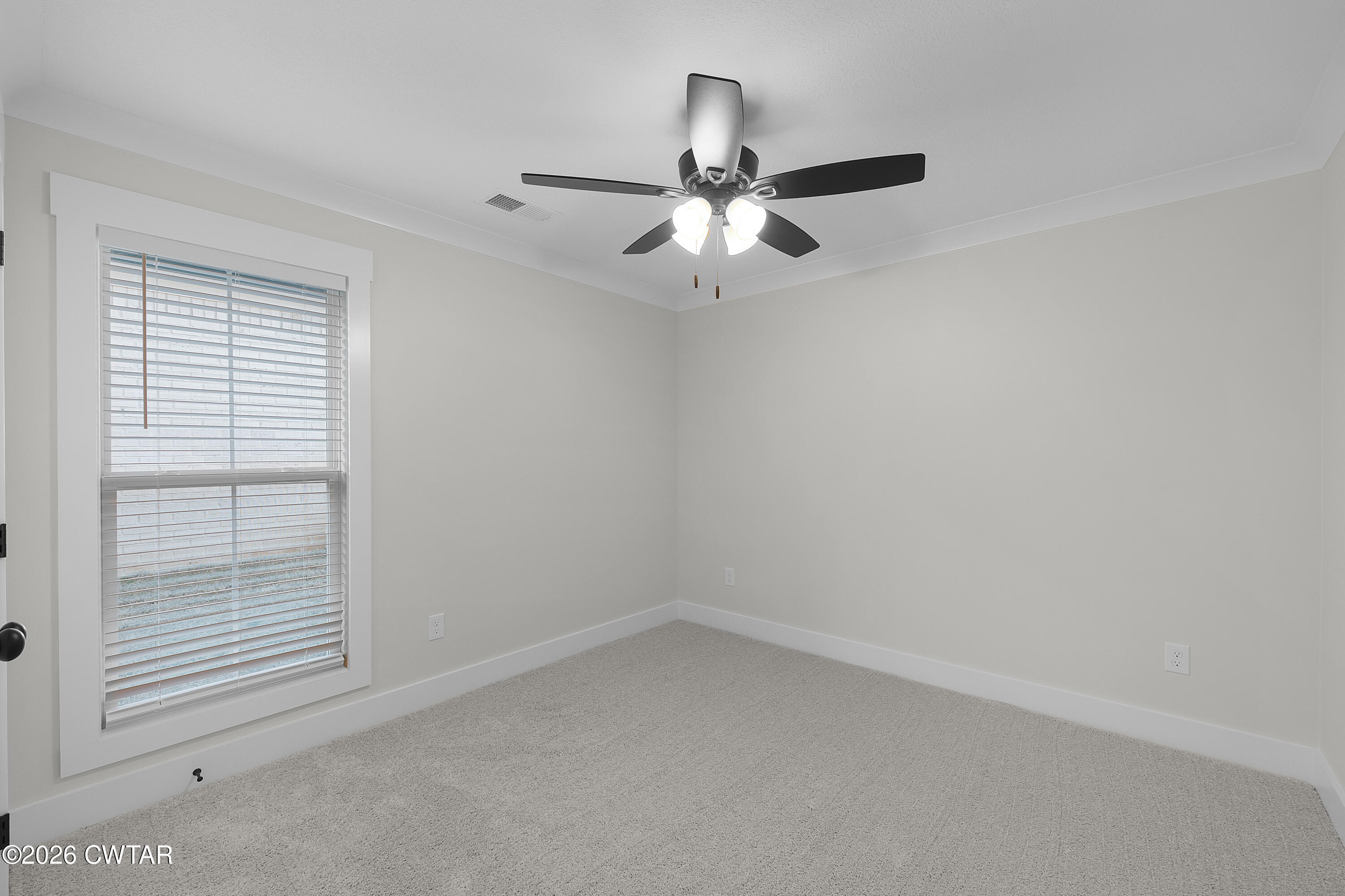 17 Easington Cove Jackson, TN 38305 - Photo 18 of 19 an empty room with a window and a fan