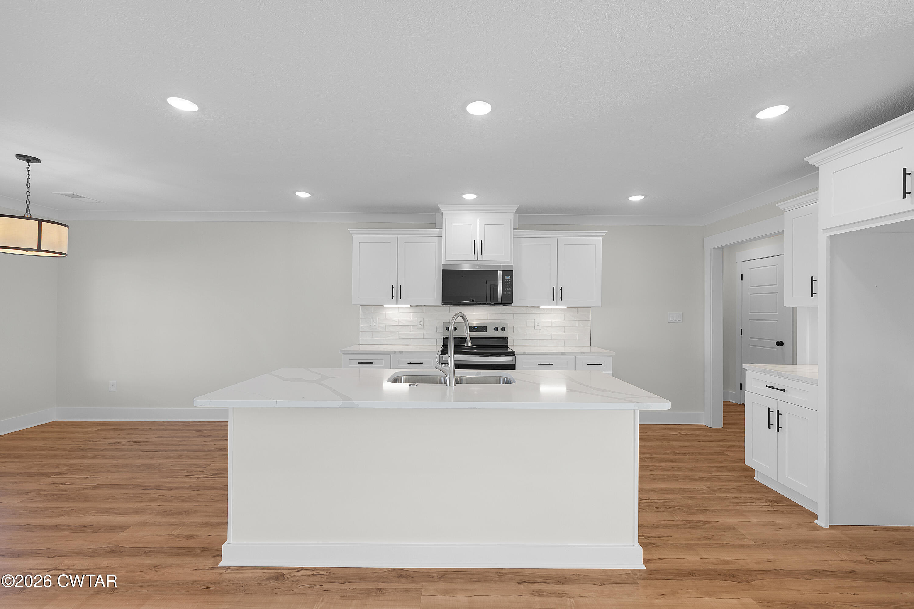 17 Easington Cove Jackson, TN 38305 - Photo 8 of 19 a kitchen with stainless steel appliances a white stove top oven and white cabinets