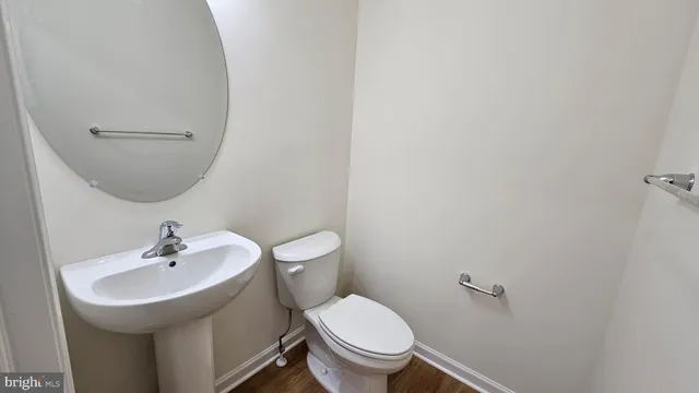 a bathroom with a sink toilet and a mirror