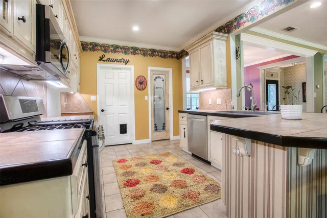 a kitchen with a sink stove and refrigerator