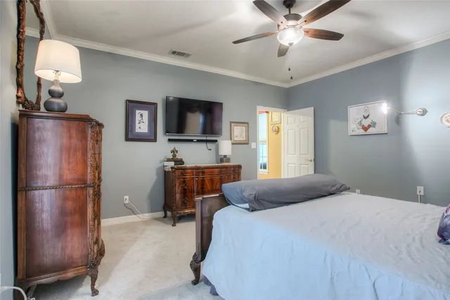 a bedroom with a bed window and a flat screen tv