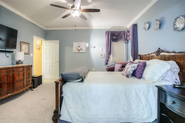 a bedroom with a bed and a flat tv screen on dresser