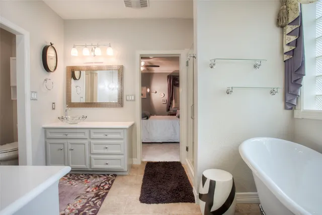 a bathroom with a toilet a sink and a mirror