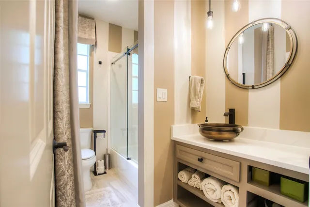 a bathroom with a sink a mirror and a shower