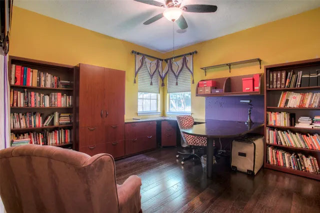 a living room with furniture piano and a bookshelf