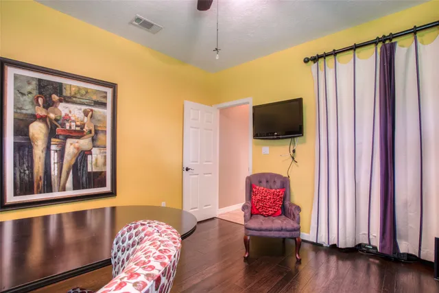 a living room with furniture and wooden floor