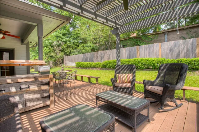 a view of a deck with wooden floor table and chairs