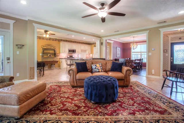 a living room with furniture a rug and a large window