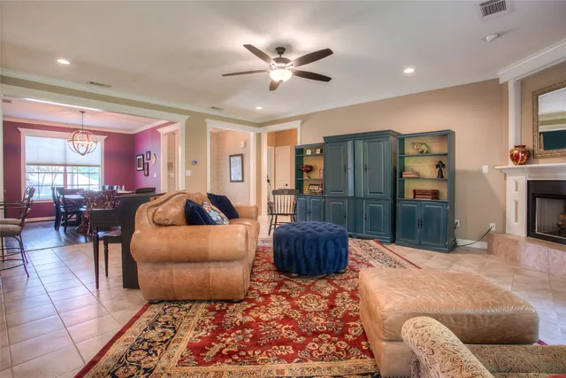 a living room with furniture a ceiling fan and a rug