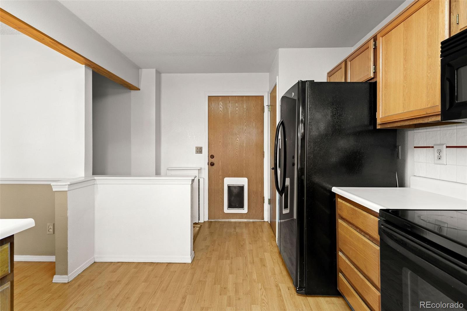 8536 Union Circle Arvada, CO 80005 - Photo 12 of 26 a kitchen with stainless steel appliances granite countertop a refrigerator and a stove top oven