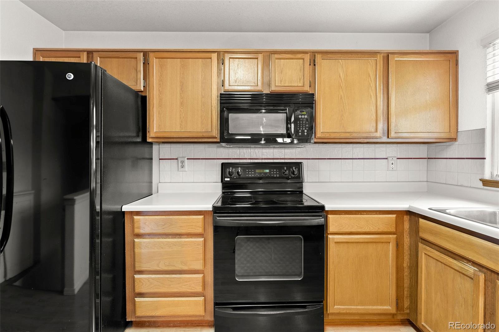 8536 Union Circle Arvada, CO 80005 - Photo 13 of 26 a kitchen with a stove a refrigerator and a sink