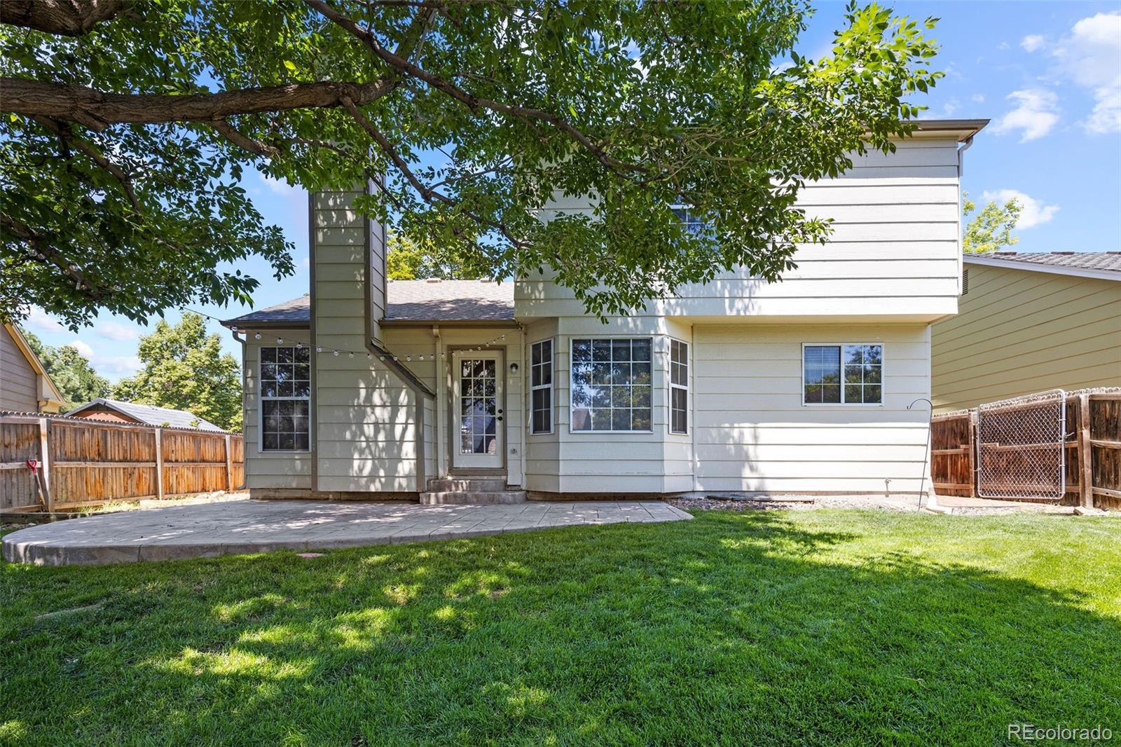 8536 Union Circle Arvada, CO 80005 - Photo 14 of 26 a front view of a house with garden