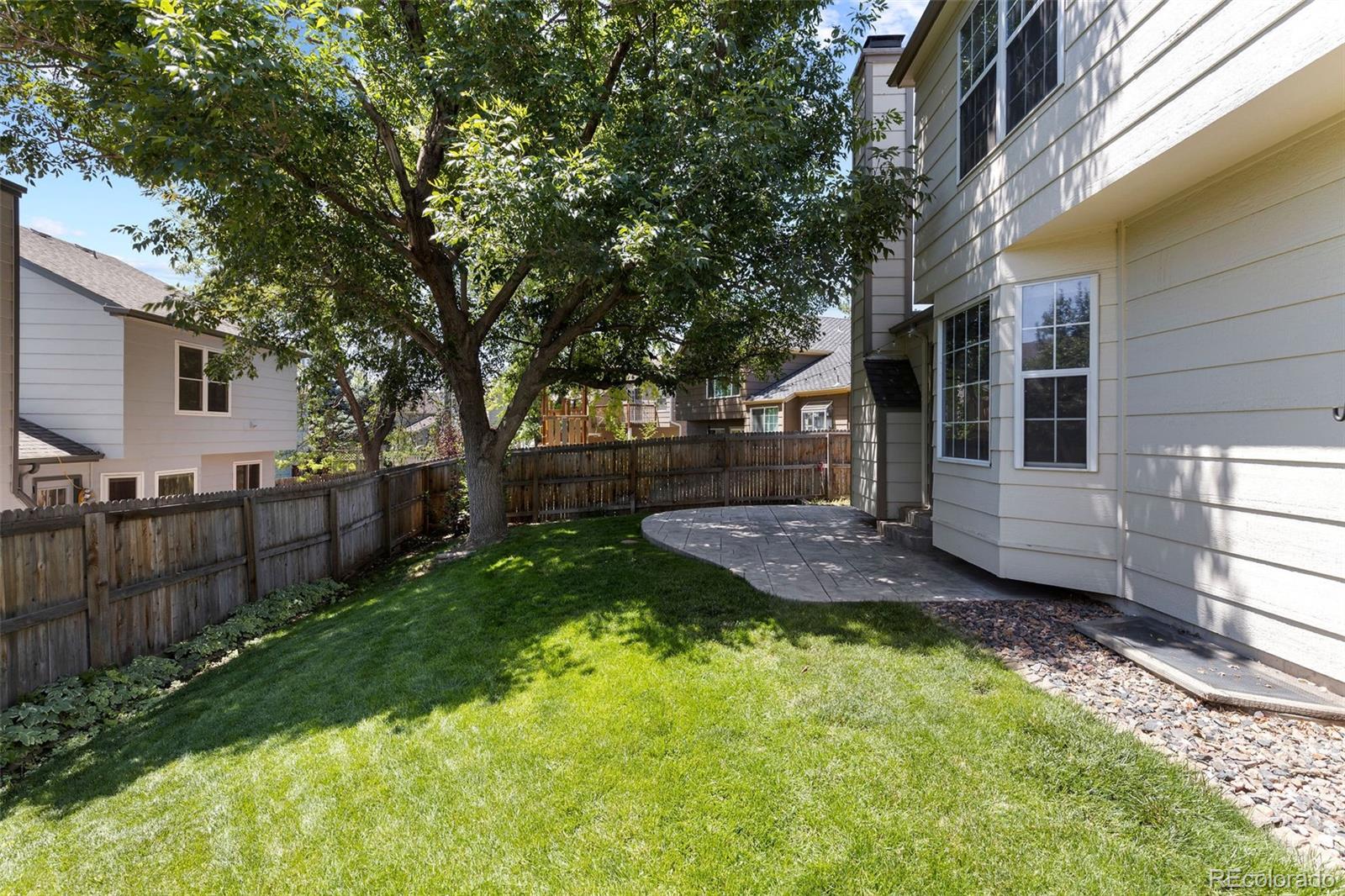 8536 Union Circle Arvada, CO 80005 - Photo 15 of 26 a view of a backyard with wooden fence and large trees
