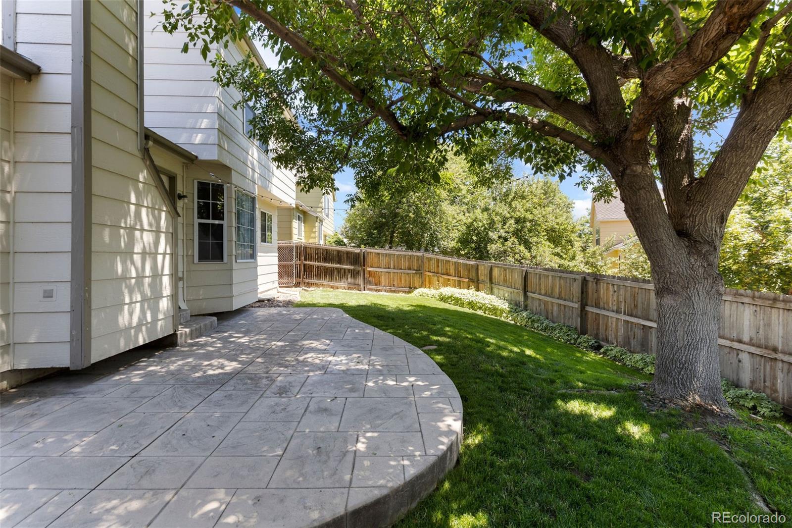 8536 Union Circle Arvada, CO 80005 - Photo 16 of 26 a view of a backyard with wooden fence and large trees