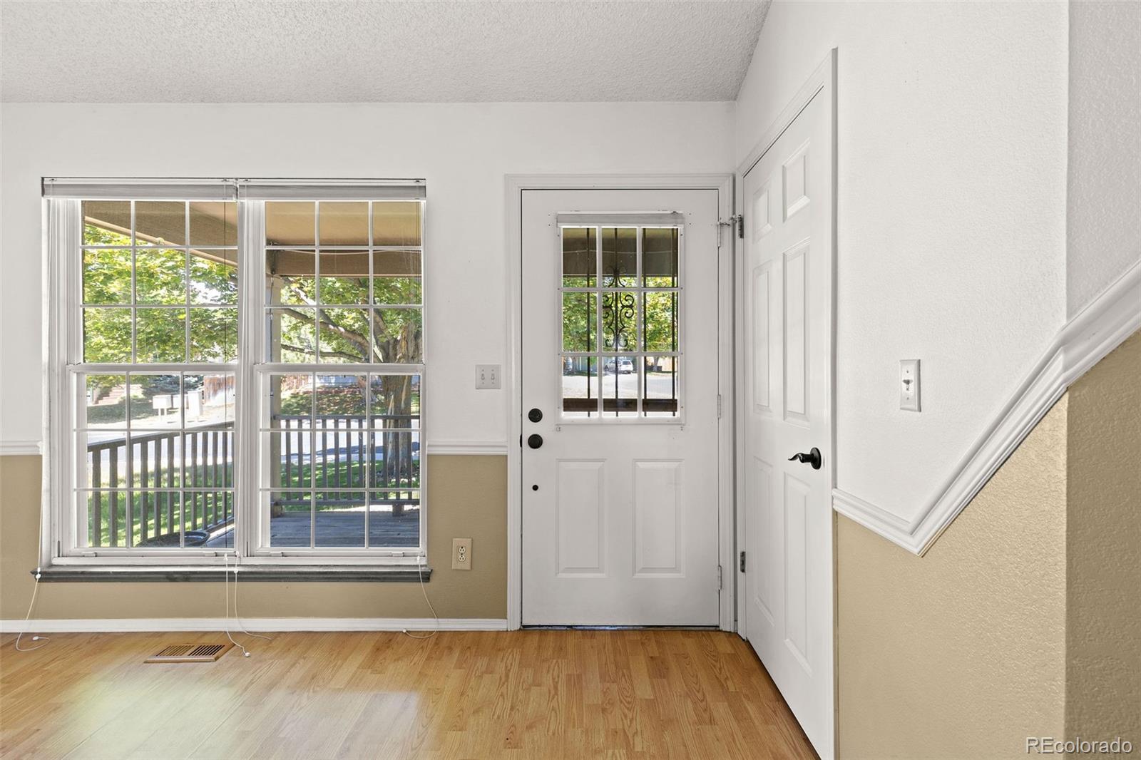8536 Union Circle Arvada, CO 80005 - Photo 2 of 26 an empty room with wooden floor and windows