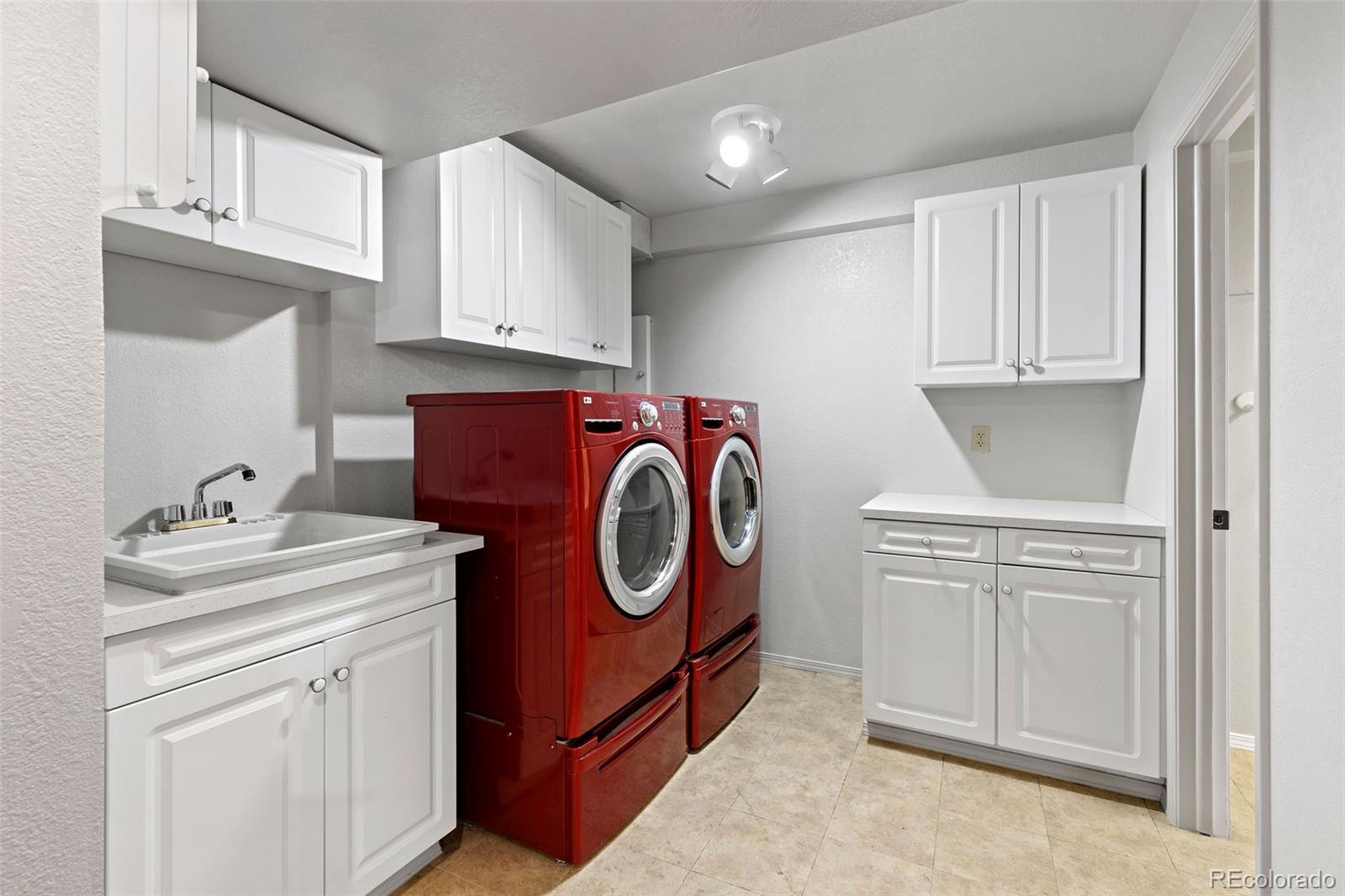 8536 Union Circle Arvada, CO 80005 - Photo 24 of 26 a utility room with sink dryer and washer